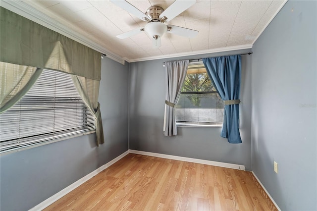 spare room with light hardwood / wood-style floors, ceiling fan, and ornamental molding