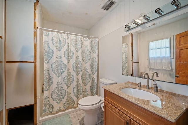 bathroom with tile patterned flooring, vanity, and toilet