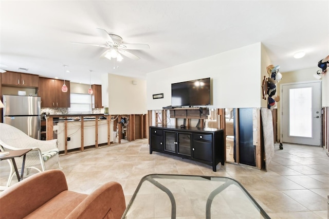 living room featuring ceiling fan and light tile patterned floors