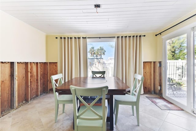 dining space featuring wood walls and wood ceiling