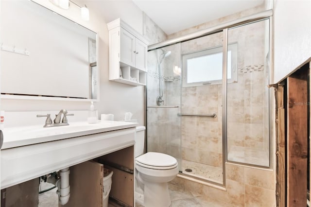 bathroom with tile patterned flooring, toilet, a shower with door, and sink