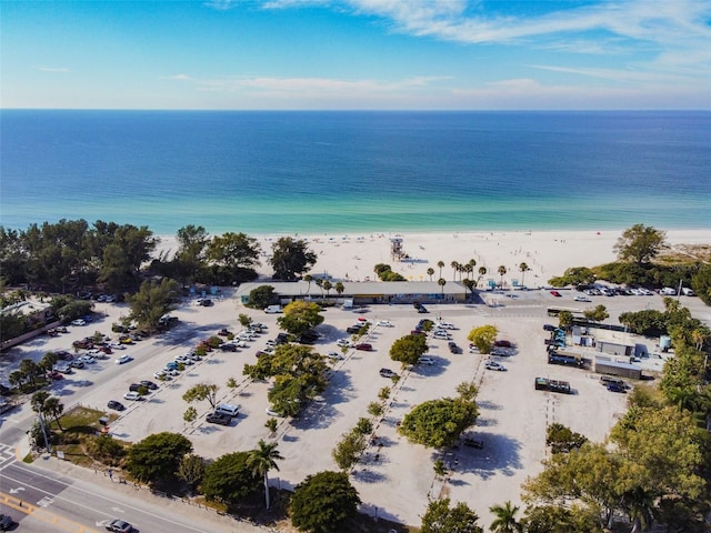 drone / aerial view featuring a water view and a beach view