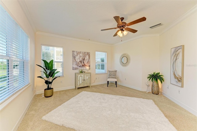 sitting room with crown molding, ceiling fan, and light carpet