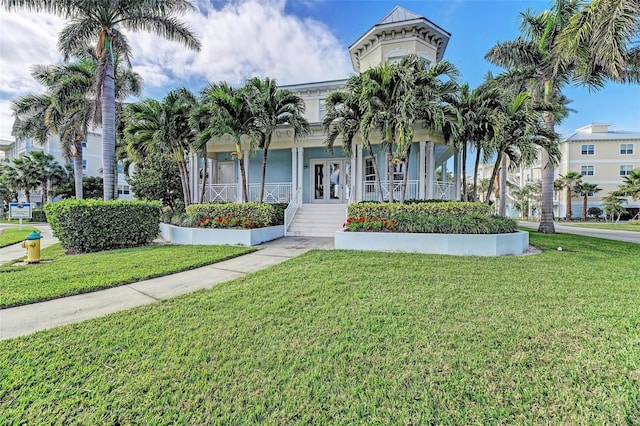 view of front of property with a porch and a front yard