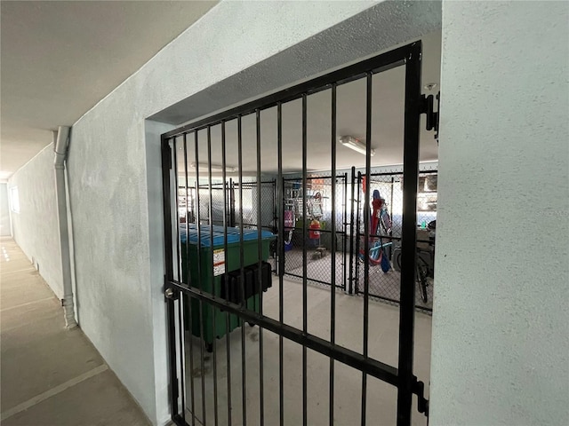 7830 34th Ave W Unit 102, Bradenton, FL 34209 - detailed view of a textured wall, concrete flooring, and a gate
