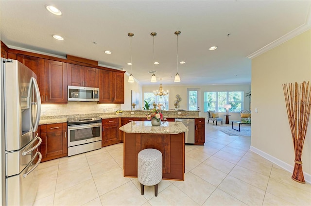 kitchen with decorative light fixtures, kitchen peninsula, ornamental molding, and appliances with stainless steel finishes