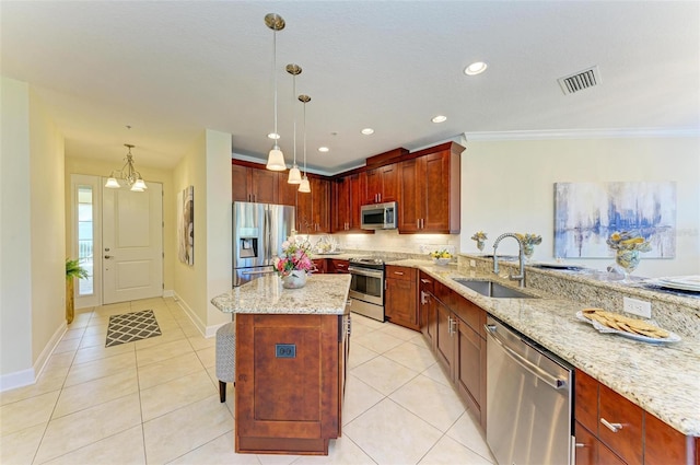 kitchen featuring sink, crown molding, light stone countertops, decorative light fixtures, and stainless steel appliances