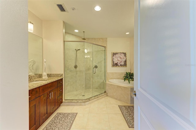 bathroom featuring tile patterned floors, separate shower and tub, and vanity