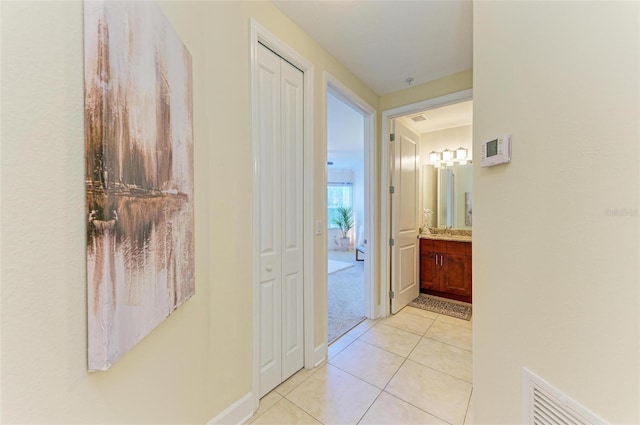 hallway featuring light tile patterned floors