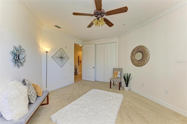 carpeted bedroom with ceiling fan, a closet, and ornamental molding