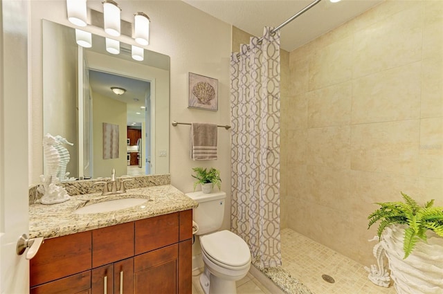 bathroom with vanity, a shower with shower curtain, and toilet