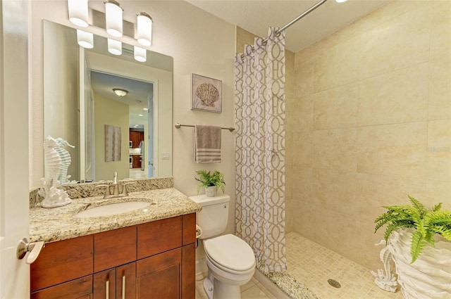 7830 34th Ave W Unit 102, Bradenton, FL 34209 - bathroom with toilet, tiled shower, and vanity