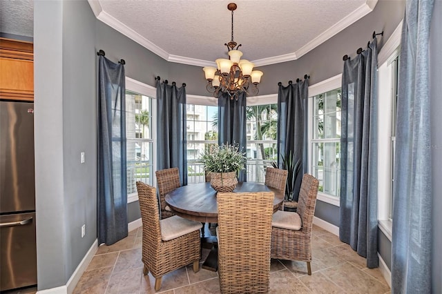 7830 34th Ave W Unit 102, Bradenton, FL 34209 - dining space with a textured ceiling, a chandelier, baseboards, and ornamental molding