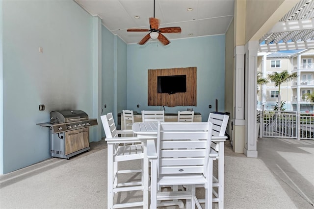 dining space with a towering ceiling, light colored carpet, and ceiling fan