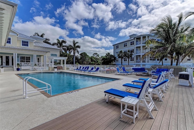 view of swimming pool with a patio area and a wooden deck