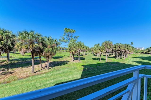 view of home's community with a rural view and a lawn