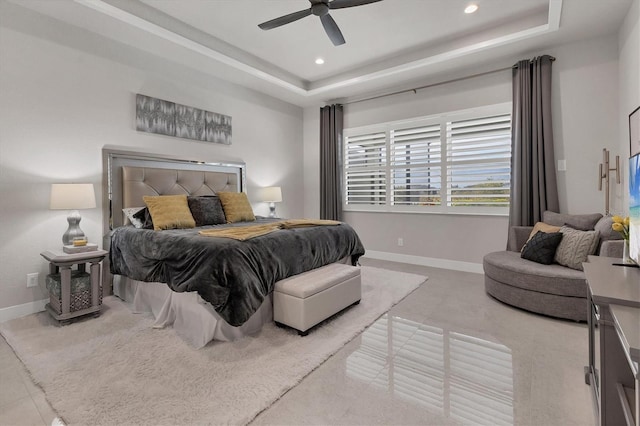 bedroom featuring ceiling fan and a tray ceiling