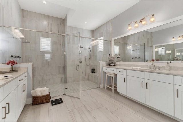 bathroom featuring a shower with door, vanity, and tile patterned flooring