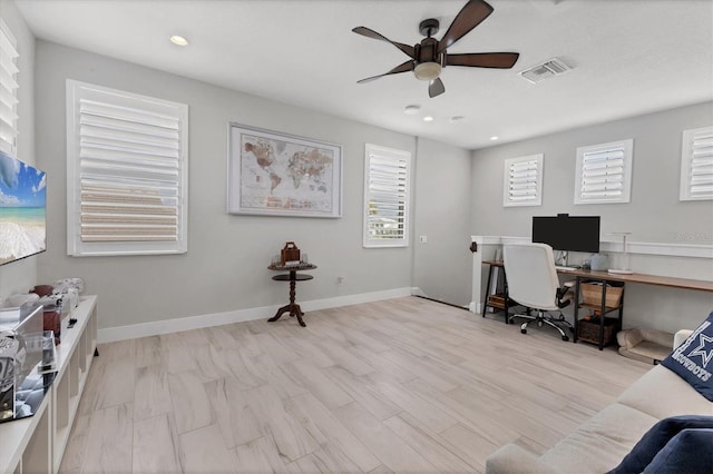 office with ceiling fan and light hardwood / wood-style flooring