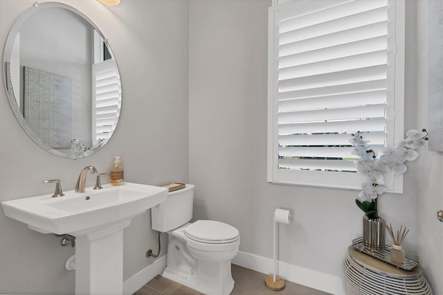 bathroom featuring sink, tile patterned flooring, and toilet