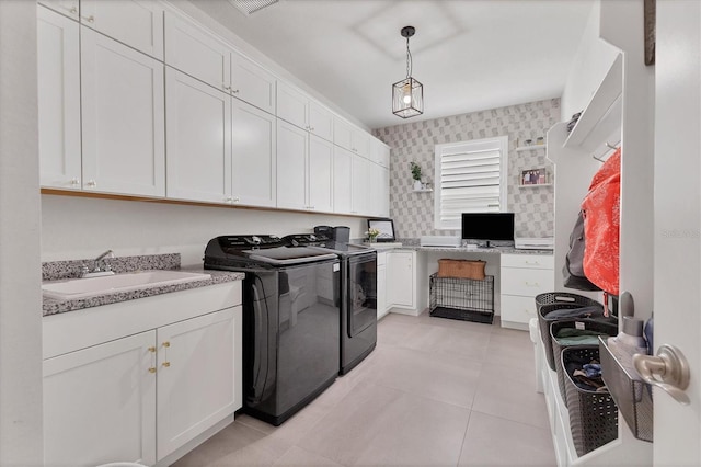 clothes washing area with cabinets, independent washer and dryer, light tile patterned flooring, and sink