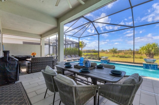 view of patio / terrace with pool water feature, an outdoor living space, ceiling fan, and a lanai