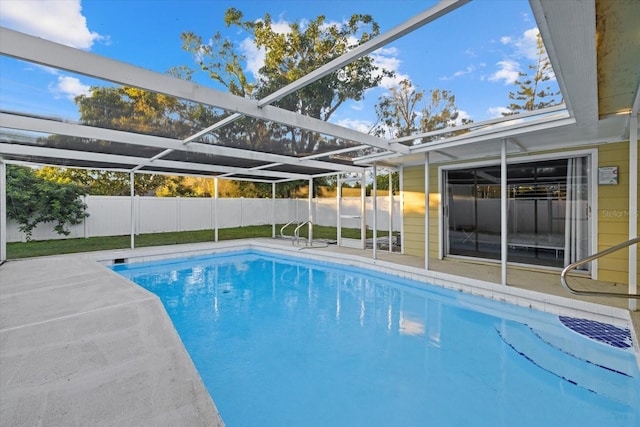 view of pool featuring glass enclosure and a patio