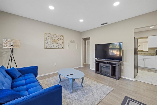 living room with light hardwood / wood-style floors