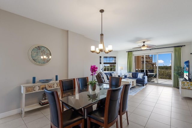 dining room featuring light tile patterned floors and ceiling fan with notable chandelier