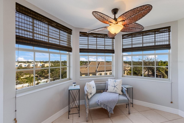 sitting room featuring ceiling fan, plenty of natural light, and light tile patterned floors