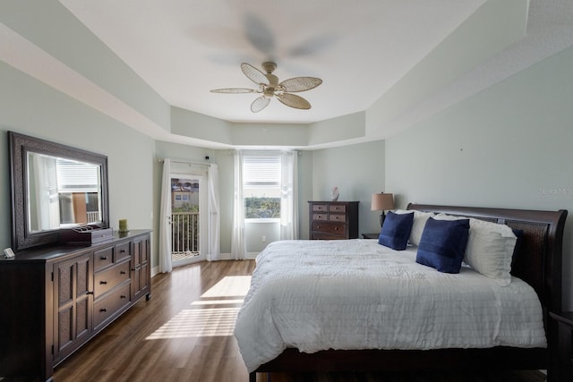 bedroom with access to exterior, dark hardwood / wood-style floors, and ceiling fan