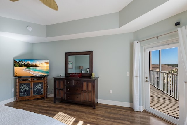 bedroom with access to exterior, dark hardwood / wood-style floors, and ceiling fan