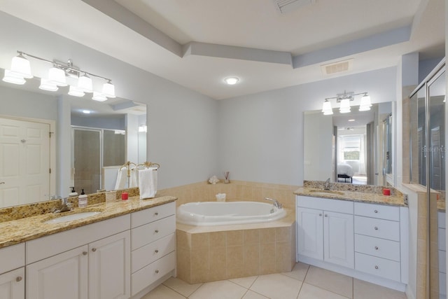 bathroom with tile patterned floors, a raised ceiling, plus walk in shower, and vanity