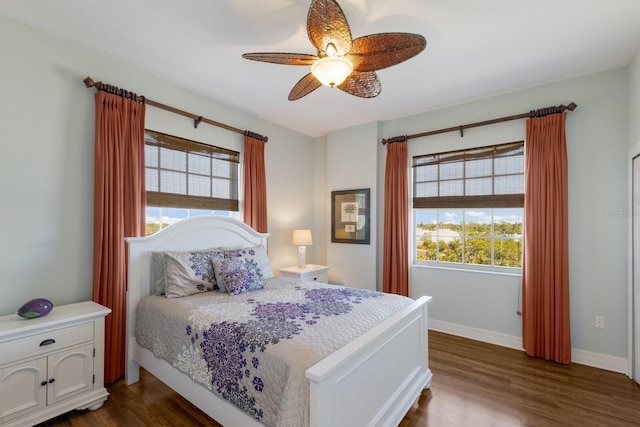 bedroom with ceiling fan and dark hardwood / wood-style floors