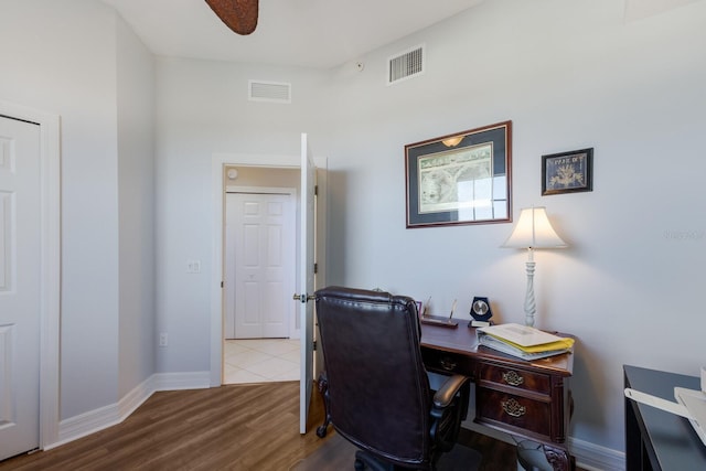 office space featuring light hardwood / wood-style floors and ceiling fan