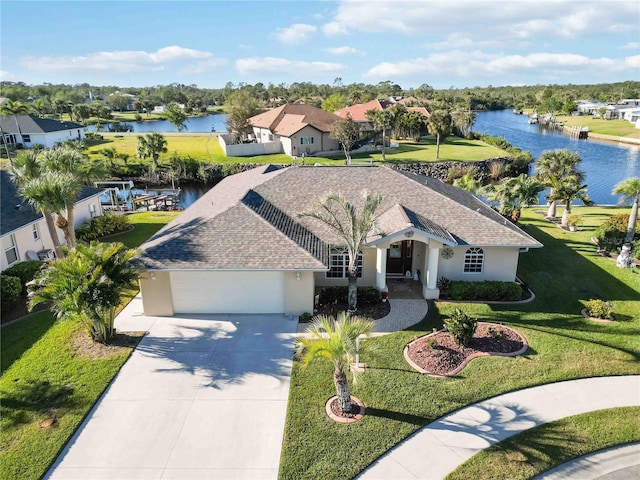 view of front facade with a garage and a water view