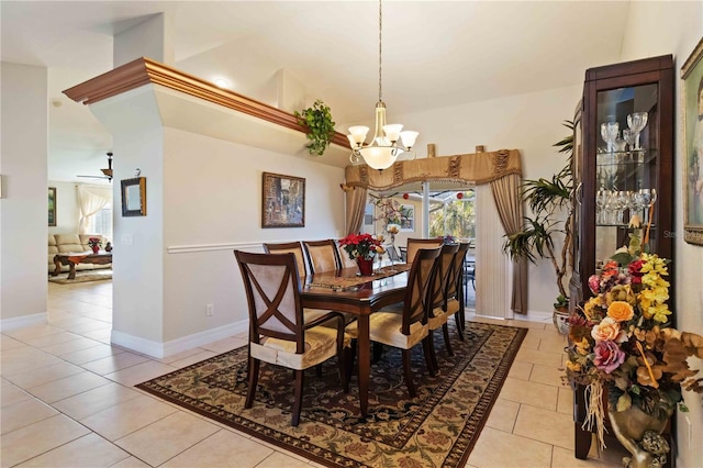 dining room featuring light tile patterned floors, ceiling fan with notable chandelier, and high vaulted ceiling