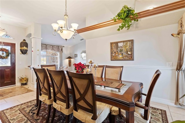 tiled dining area with a notable chandelier and a healthy amount of sunlight