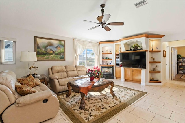 tiled living room with built in shelves and ceiling fan