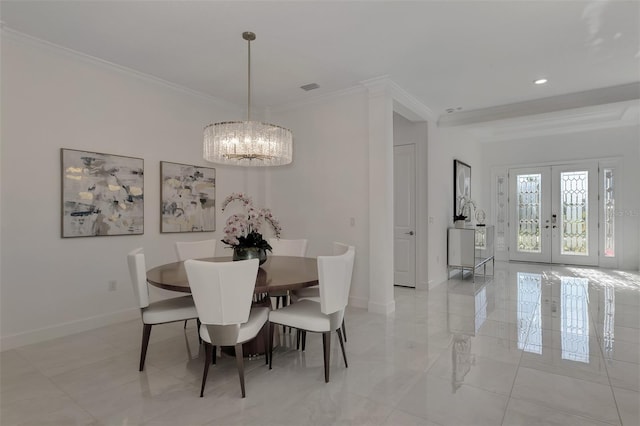 dining space featuring a chandelier, french doors, and crown molding