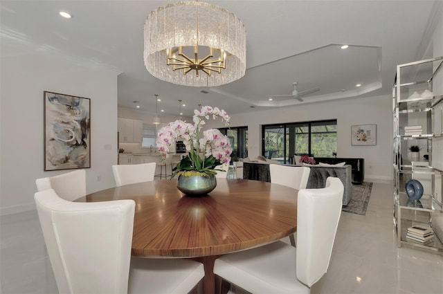 dining space featuring a raised ceiling, crown molding, light tile patterned floors, and ceiling fan with notable chandelier