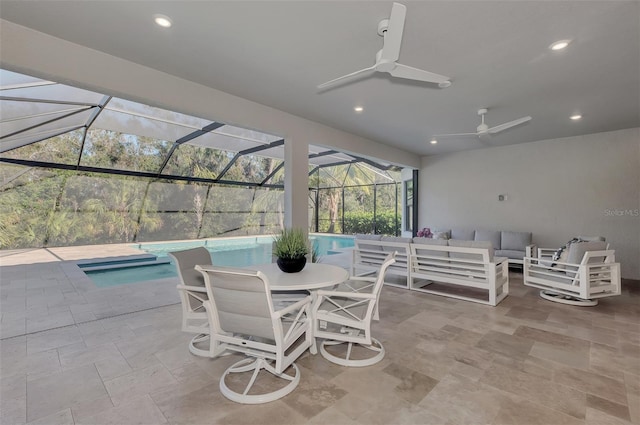 view of patio / terrace featuring outdoor lounge area, glass enclosure, and ceiling fan