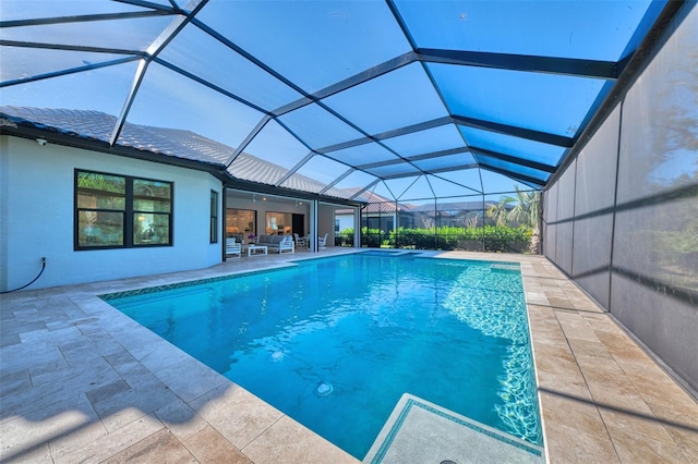 view of pool with a patio area and a lanai