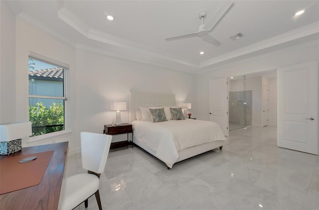 bedroom featuring a tray ceiling, ensuite bath, ceiling fan, and crown molding