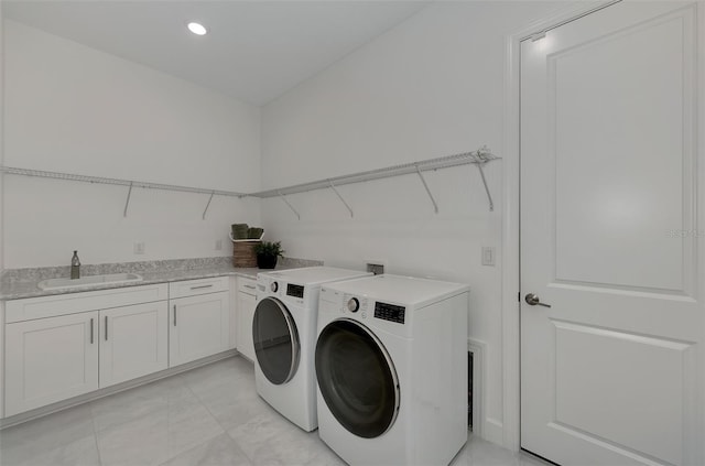 washroom featuring washer and clothes dryer, cabinets, and sink