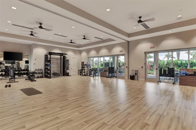 15603 Derna Ter, Bradenton, FL 34211 - exercise room featuring a ceiling fan, a raised ceiling, recessed lighting, light wood finished floors, and a towering ceiling