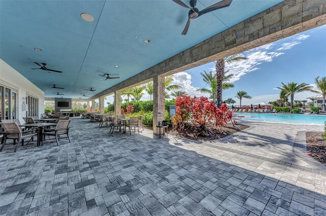 15603 Derna Ter, Bradenton, FL 34211 - view of patio / terrace featuring outdoor dining area, a ceiling fan, and a community pool
