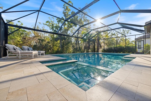 view of swimming pool with a lanai, a pool with connected hot tub, and a patio