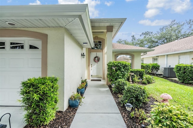 doorway to property with a yard and central AC unit