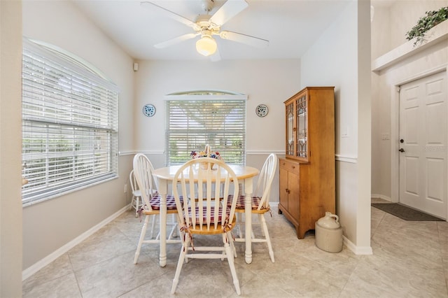 dining area with ceiling fan and light tile patterned flooring